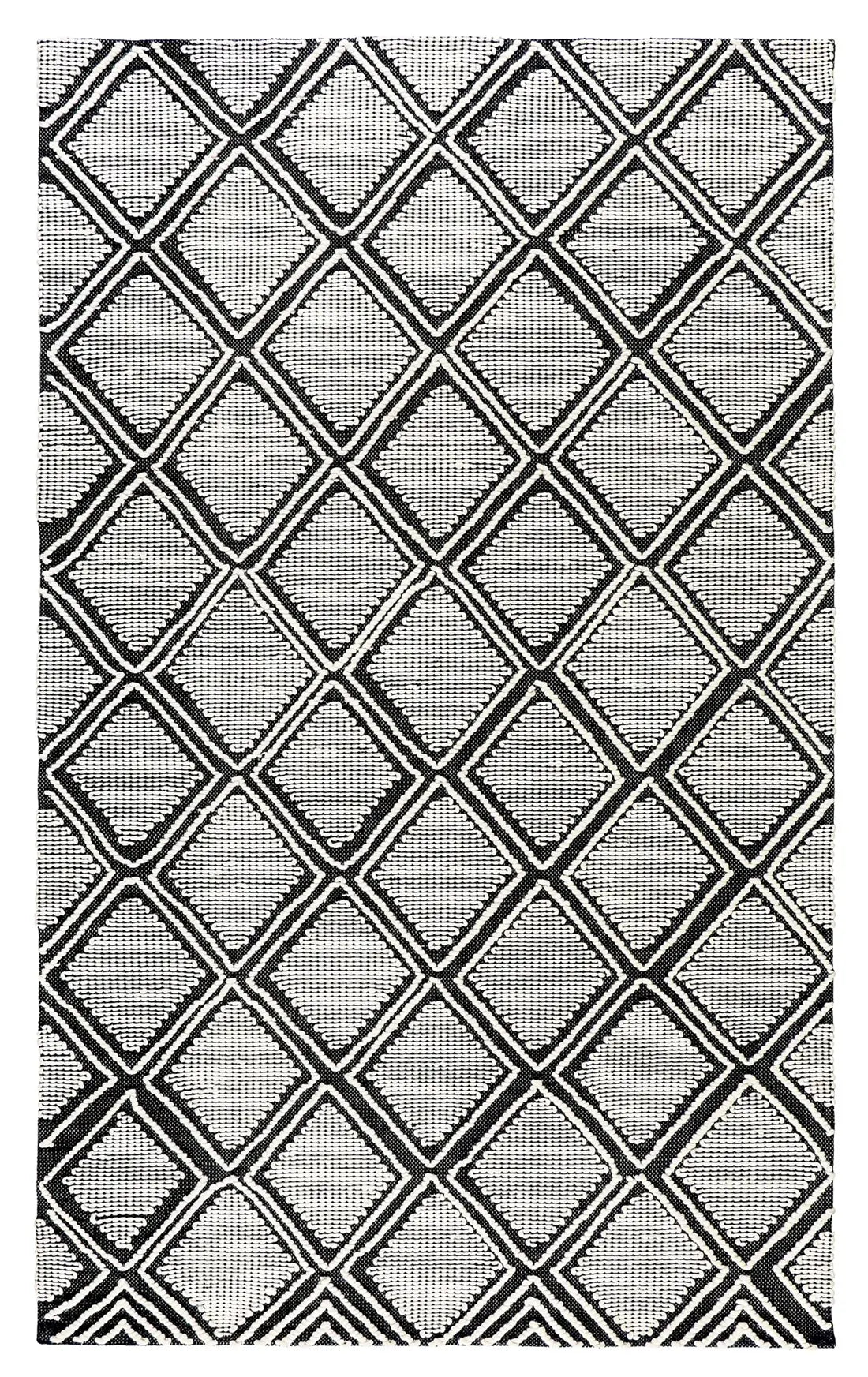 flatweave area rug featuring a bold black and white geometric diamond pattern