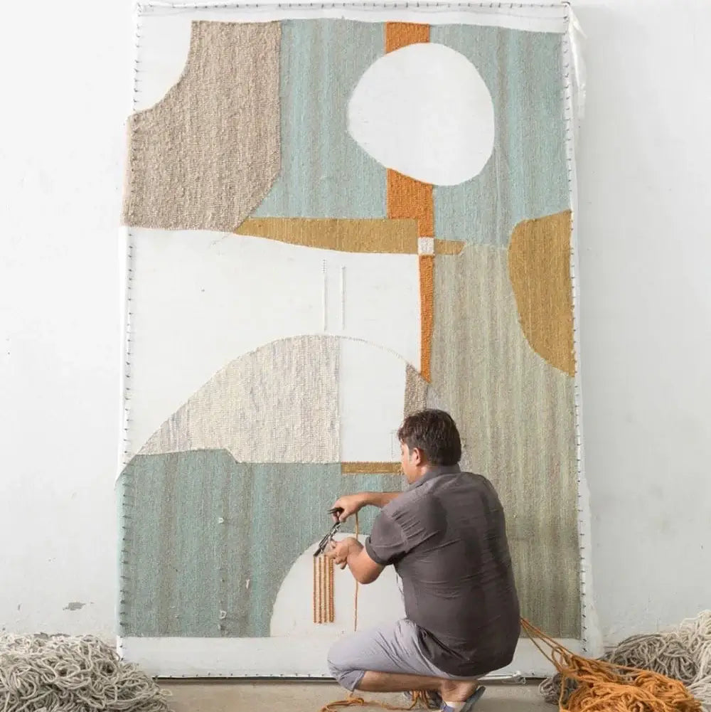 artisan making a hand tufted rug