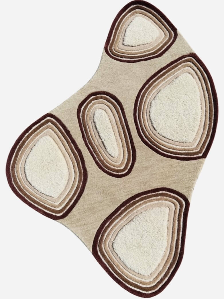 Beige and brown area rug with circular patterns