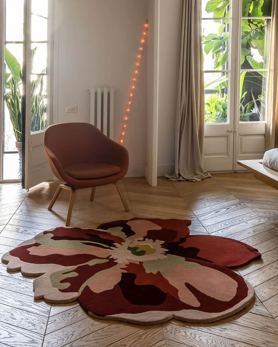 A large, flower-shaped area rug on the floor