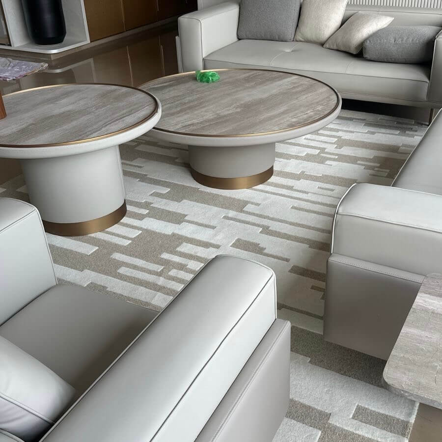 Modern living room with gray patterned rug, sofa, and coffee table