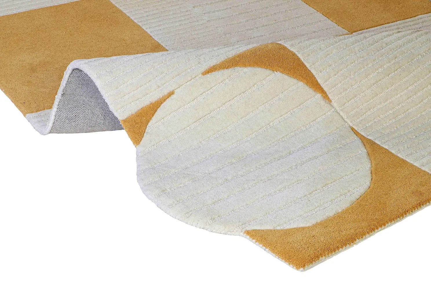 Close-up of a geometric-patterned rug with orange and white design shape