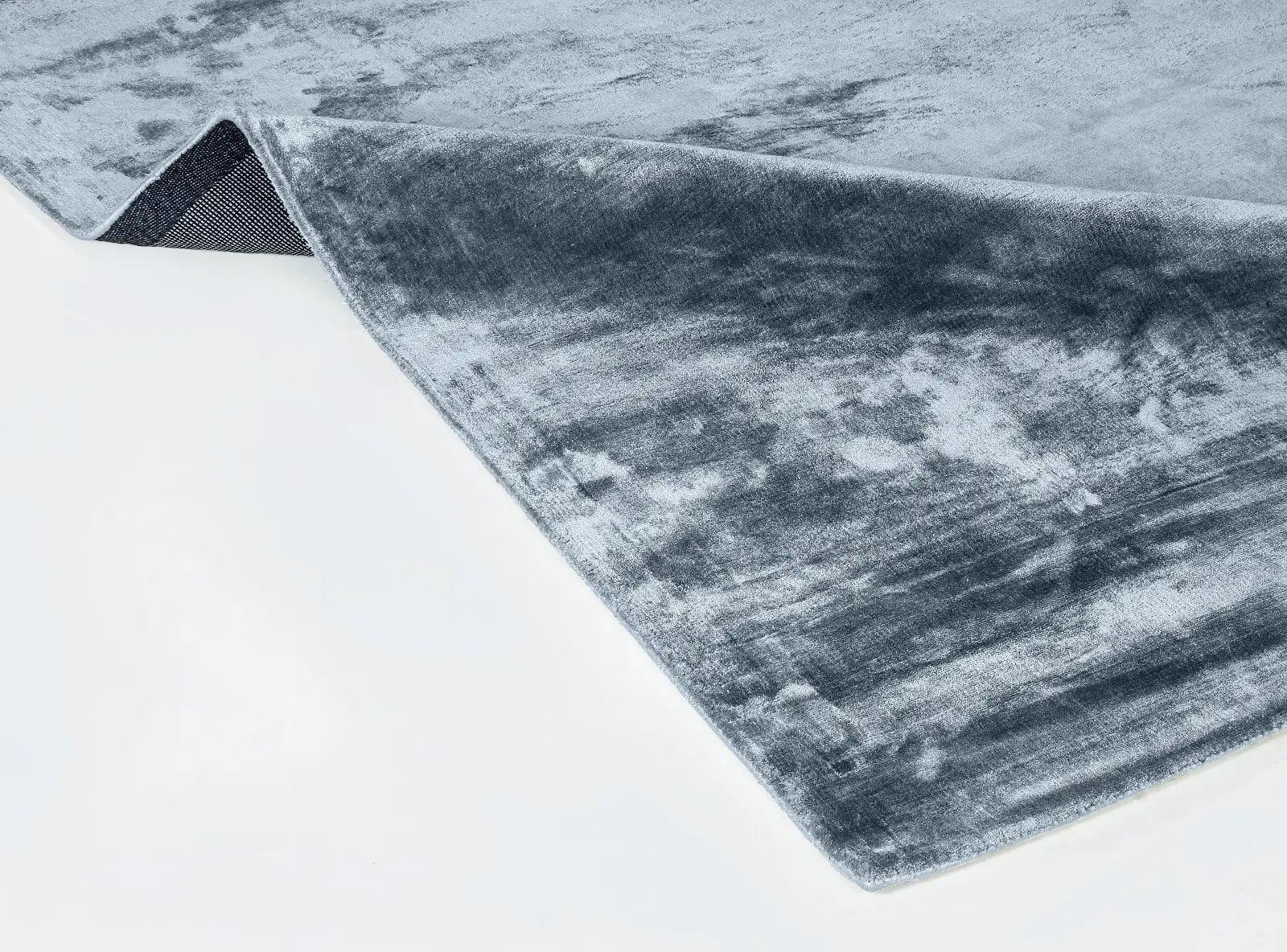 Blue Gray textured rug on a white surface