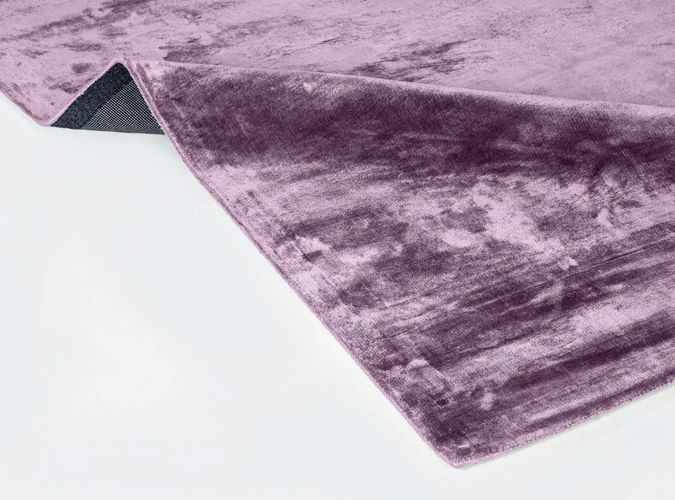Purple handloom textured rug on a white surface