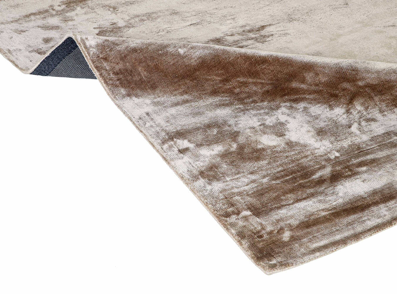 Close-up of a textured brown and beige rug corner