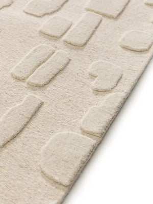 beige shaped wool rug pile