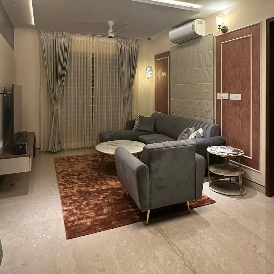 Living room with brown abstract wool rug and gray sofa