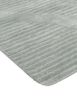 corner of a textured gray wool rug