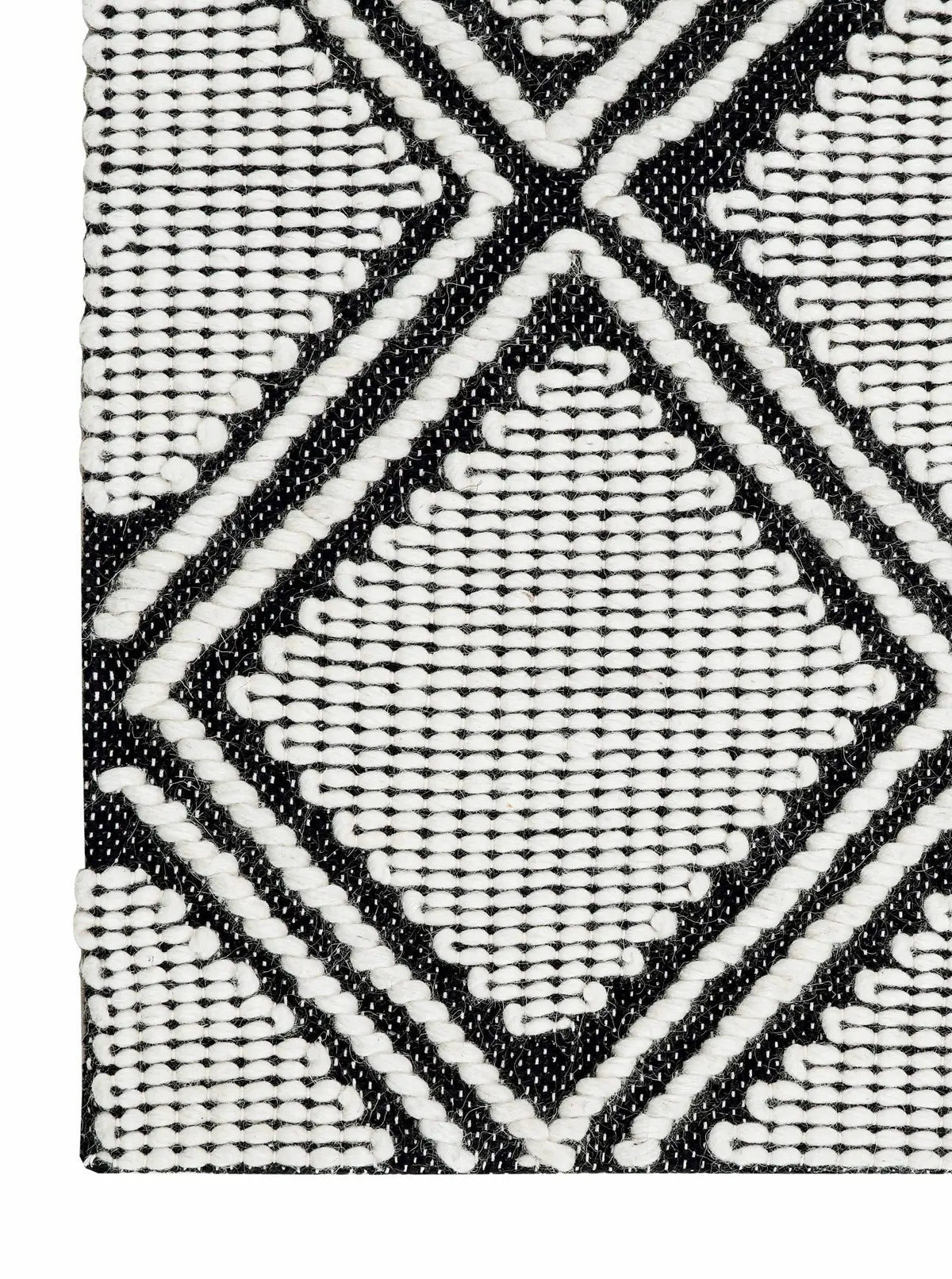 Black and white woven rug corner