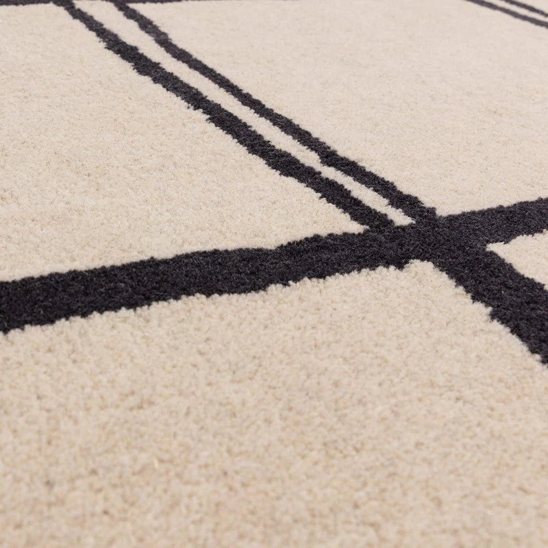 Close-up of a beige carpet with black grid