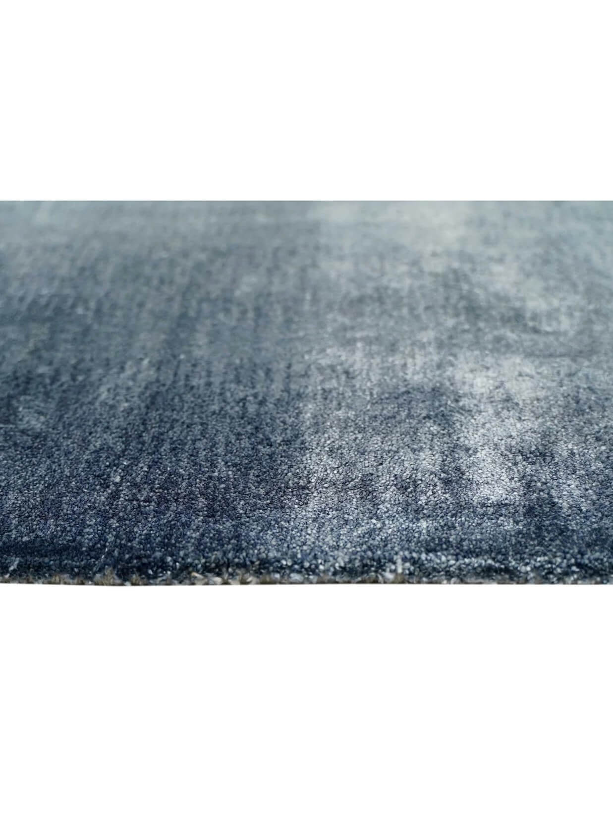 Close-up of a textured tufted blue rug