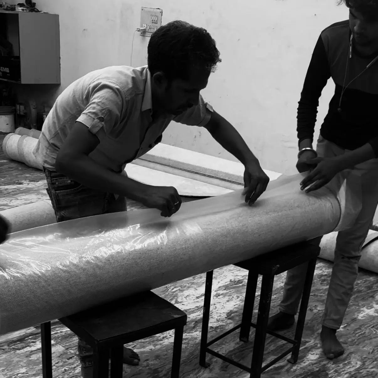 men packing rugs for parcel