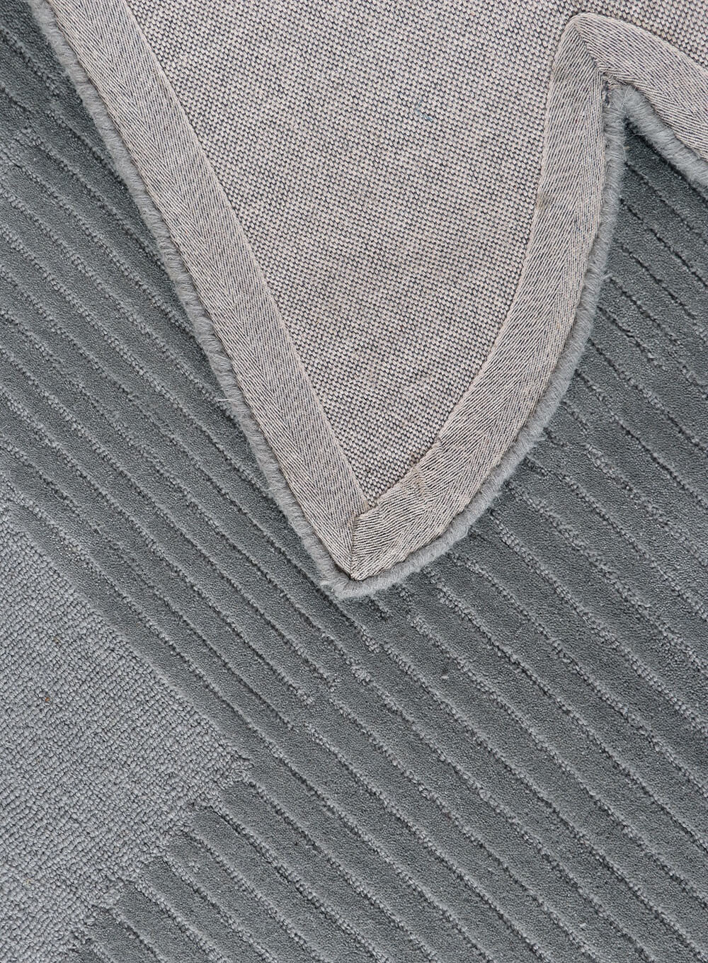grey tufted rug back side