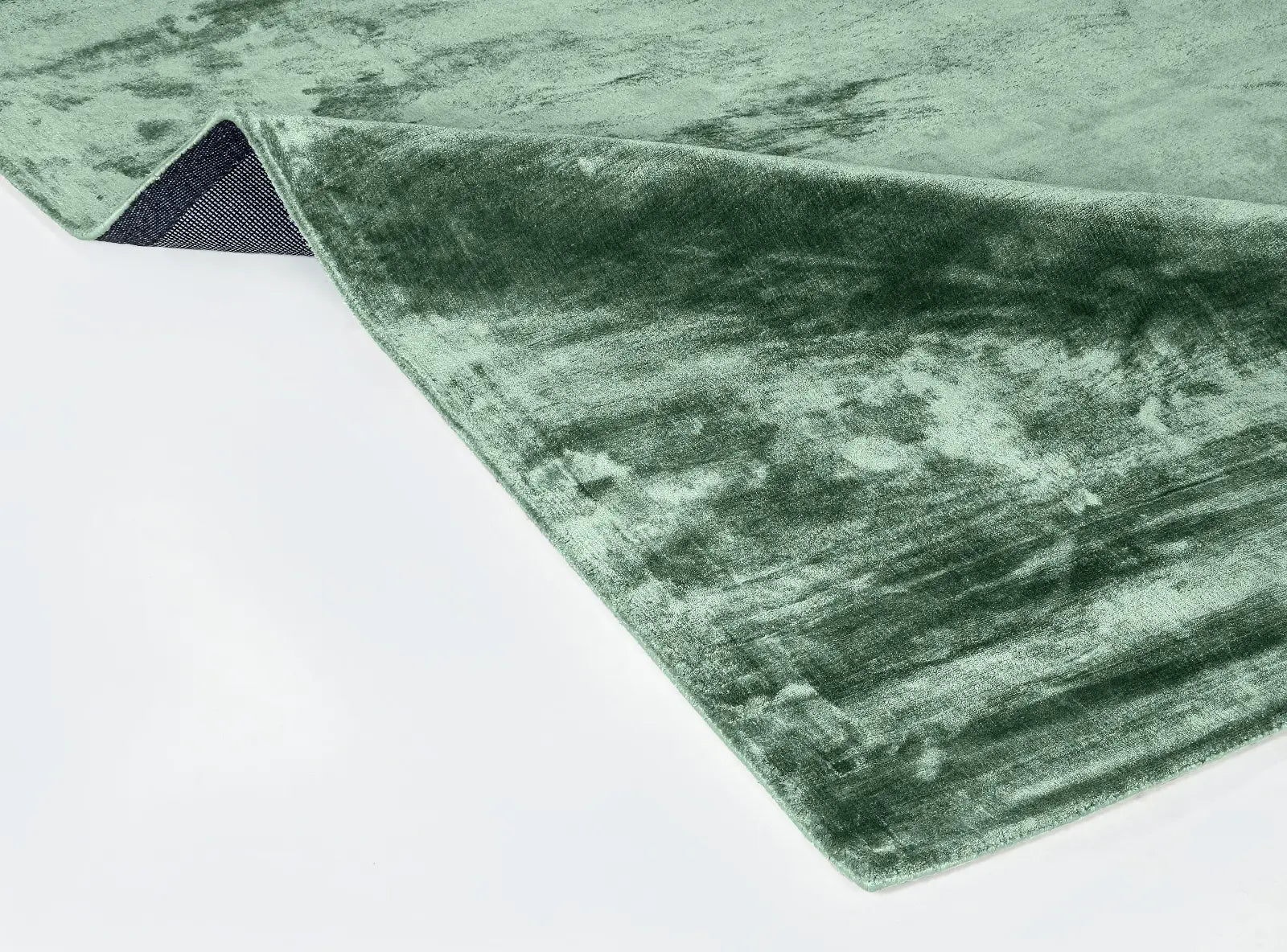 Green textured rug on a white background