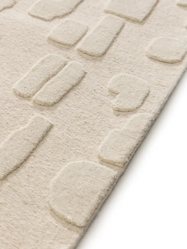 beige shaped wool rug pile